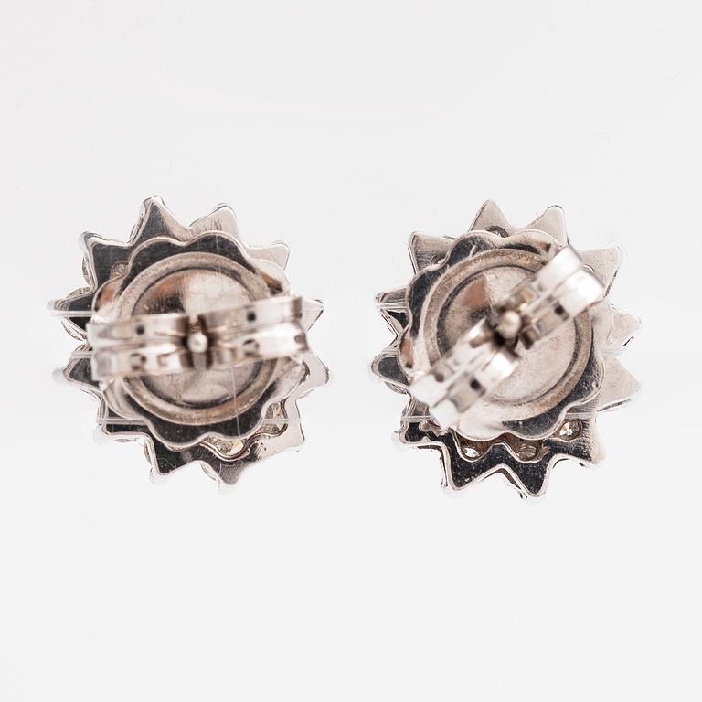 A pair of 18K white gold earrings with brilliant cut diamonds ca. 0.96 ct in total and rubies. Rubens, Helsinki.