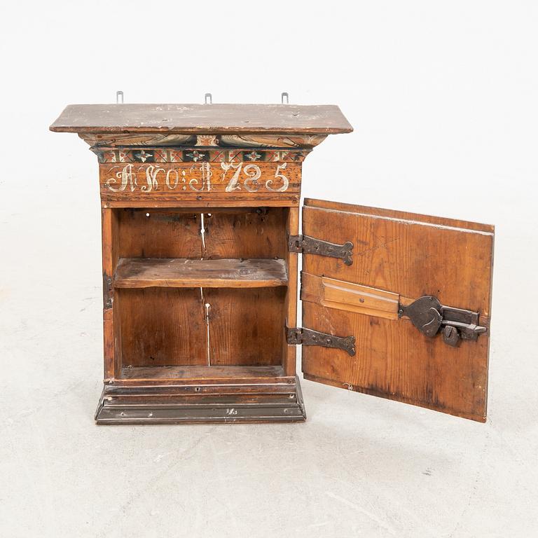 A Swedish wal cabinet dated 1785.