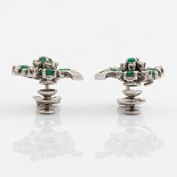 A pair of 14K white gold, emerald and round brilliant- and baguette cut diamond ear clips.