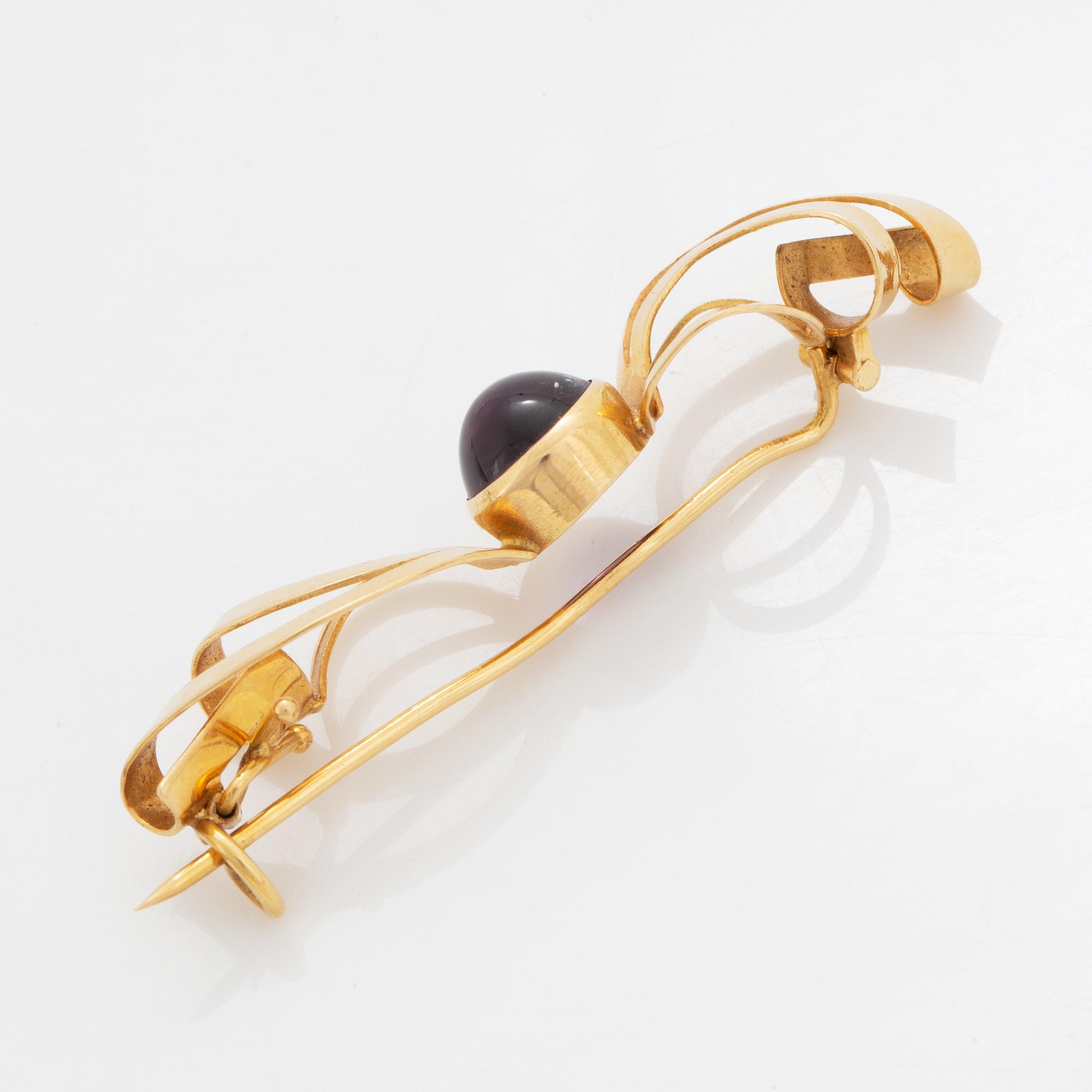 A pair of earrings and a brooch.