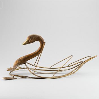 A 20th century grass newspaper stand in the shape of a swan.