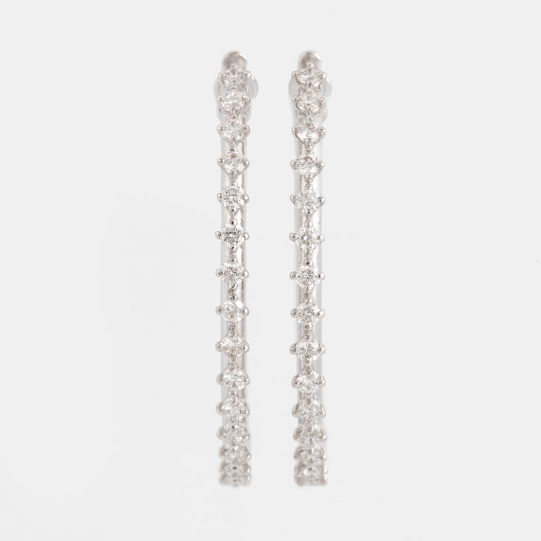 Brilliant-cut diamond hoop earrings.