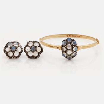 891. A moonstone and marcasite bangle and pair of earrings.