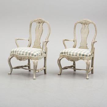 A pair of 20th century rococo style armchairs.