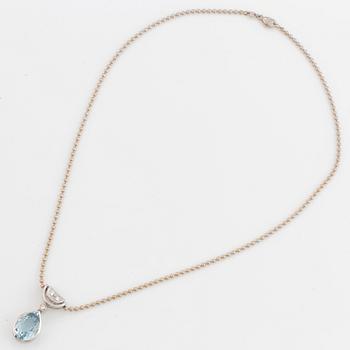 White gold chain and pendant with pearshaped topaz and brilliant-cut diamonds.