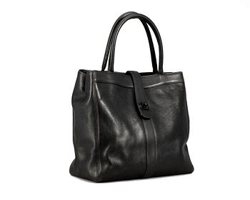 301. A black leather handbag by Chanel.