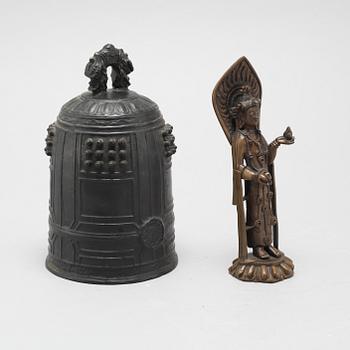 A Chinese temple bell and a figure of a deity, 20th Century.