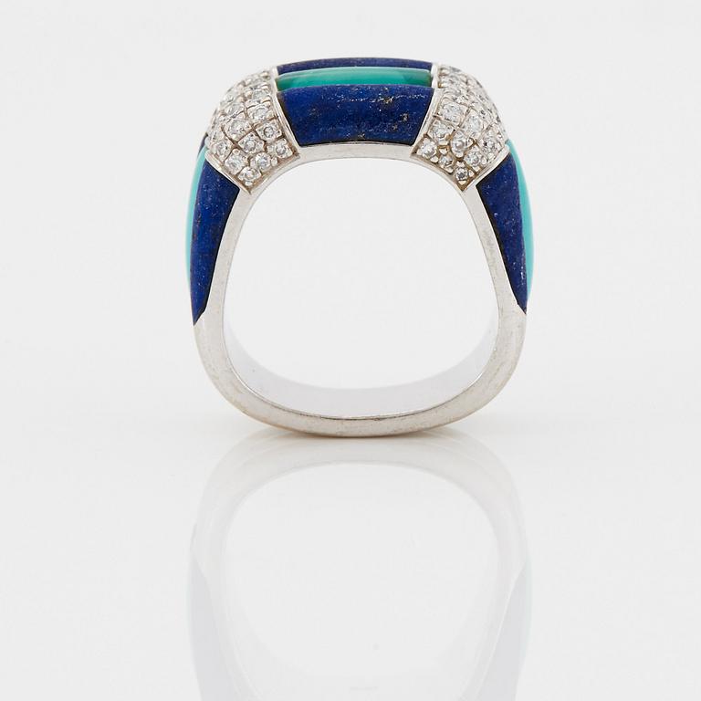 A Paul Binder ring in 18K white gold set with lapis lazuli, turquoise and round brilliant-cut diamonds.