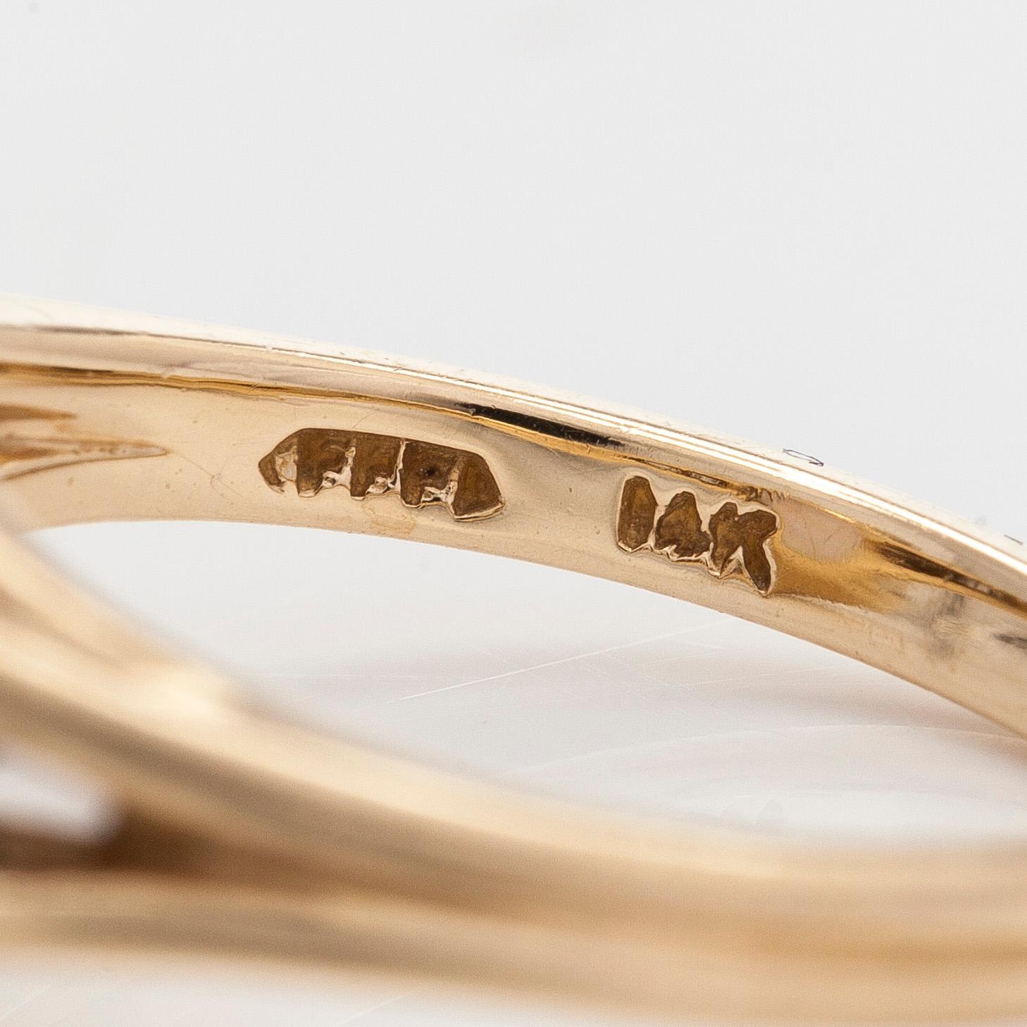 Ring in 14K gold with an oval opal and diamonds.