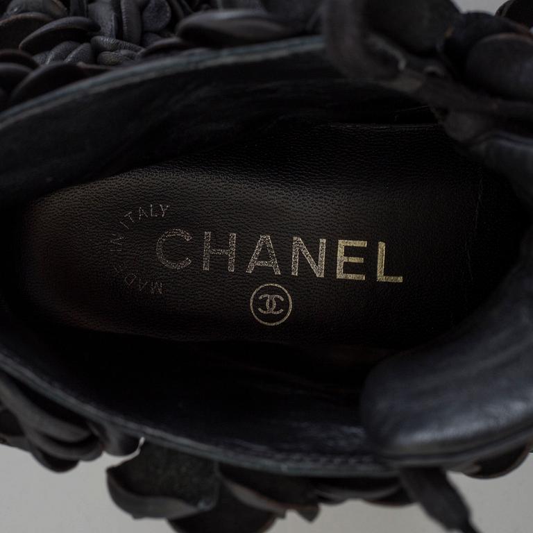 A black leather sneakers by Chanel.