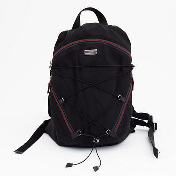 Gucci, a black canvas backpack.