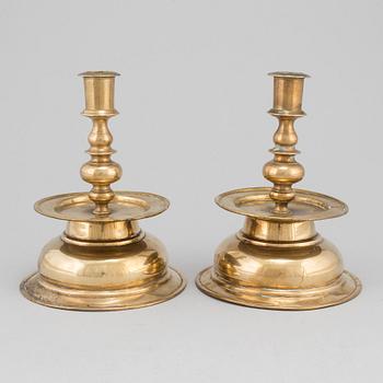 A pair of 17th century brass candlesticks.