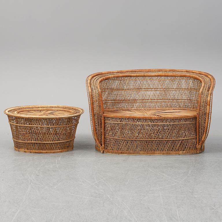 A late 20th Century rattan sofa with table.