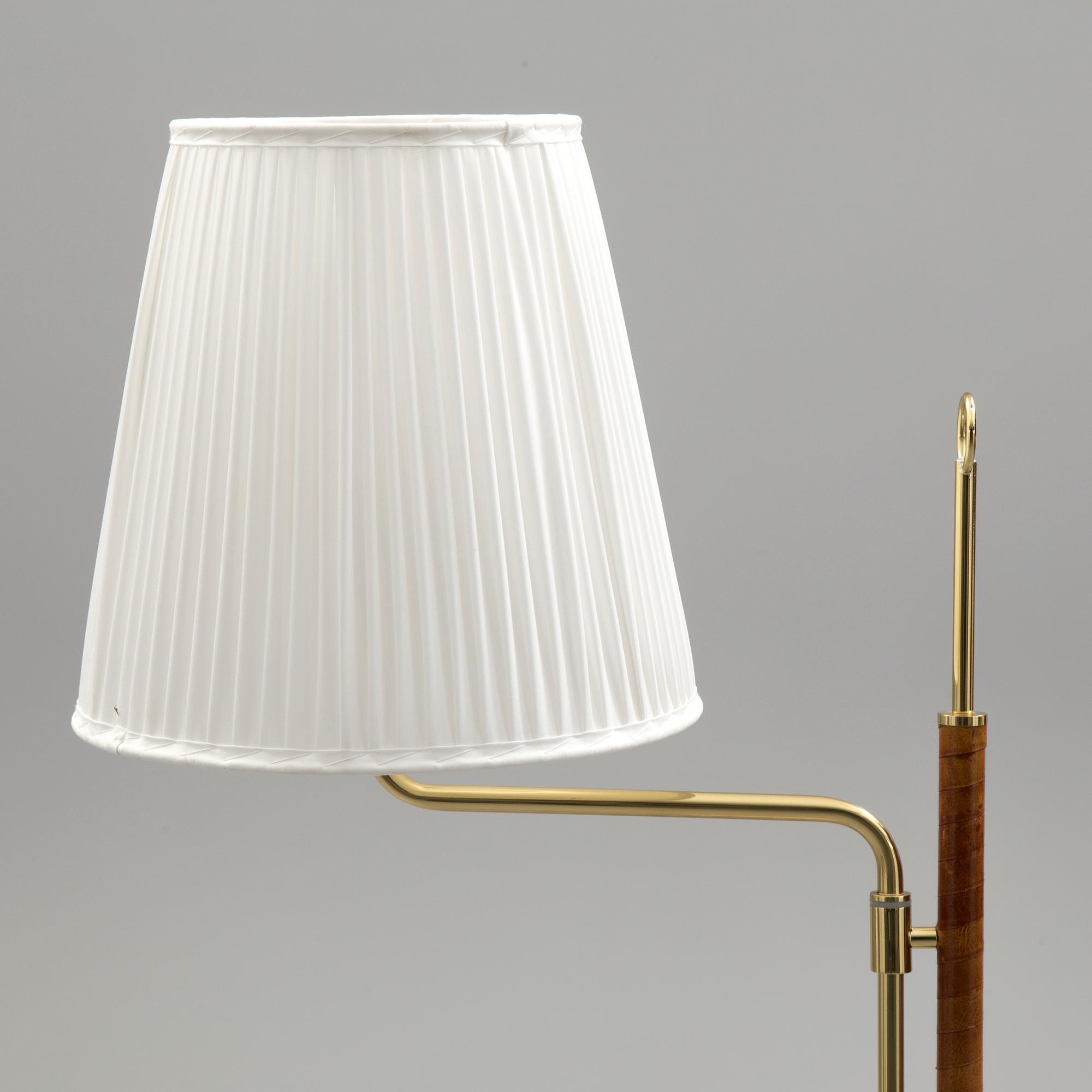 A brass and leather floor light by Örsjö industri, 21st century.