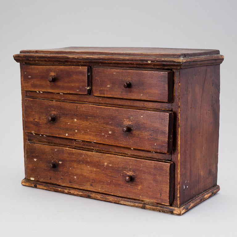 A 19th century miniature chest of drawers.