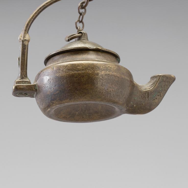 A 18th century oil lamp.