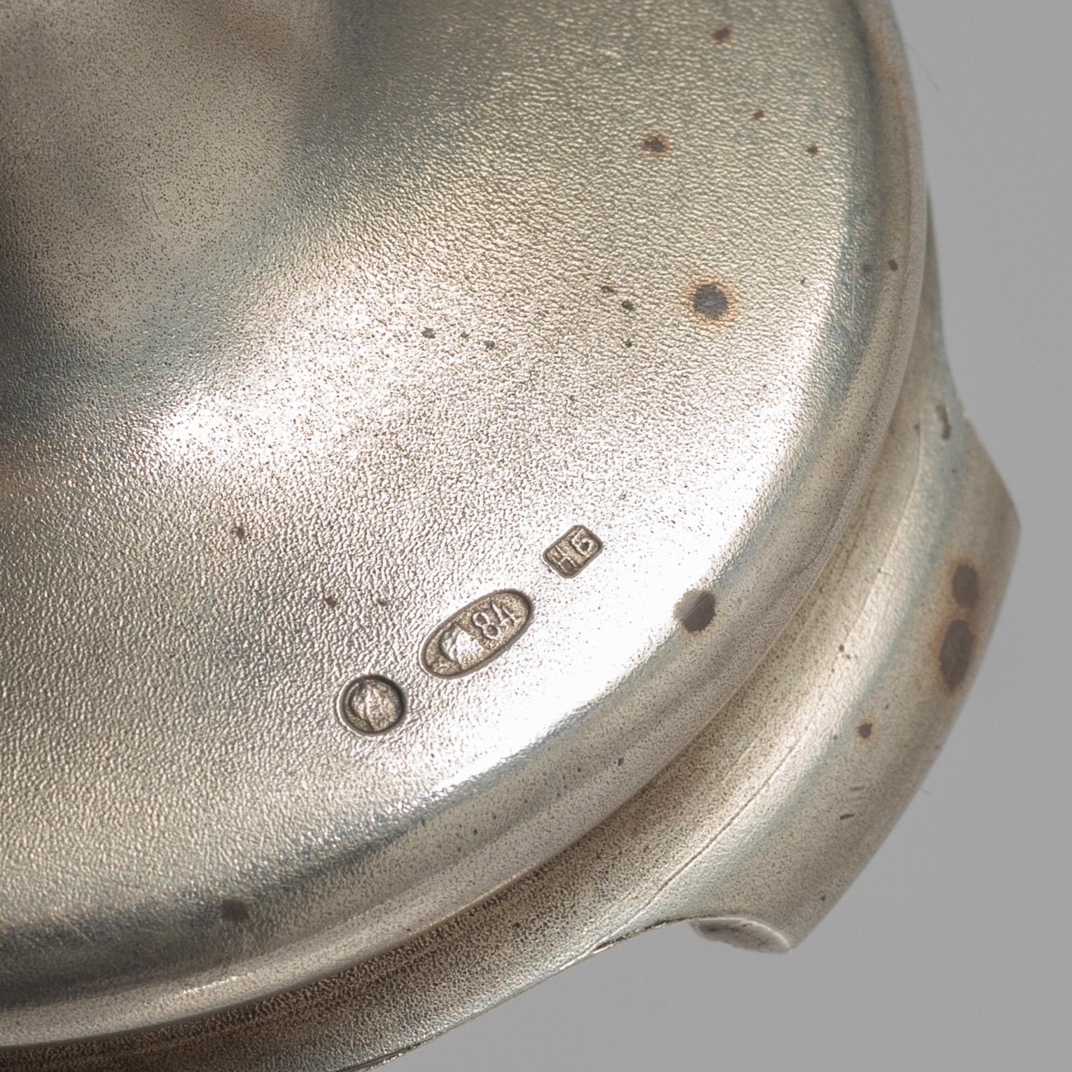 A Russian Silver Candlestick, 1908-26, and a Russian Silver Tea Glass Holder, assay master A. Skovronsky, Moscow 1896.