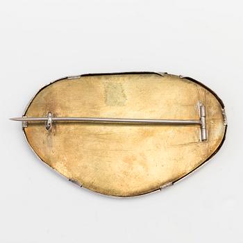 A BROOCH set with moss agate.