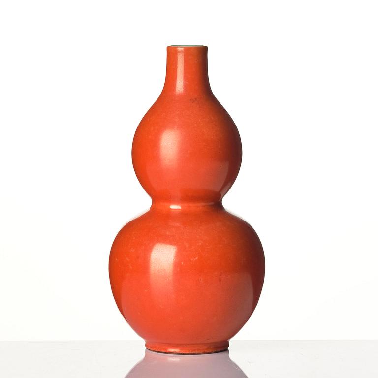 A coral red-enameled double-gourd vase, Qing dynasty with Jiaqing mark (1796-1820).