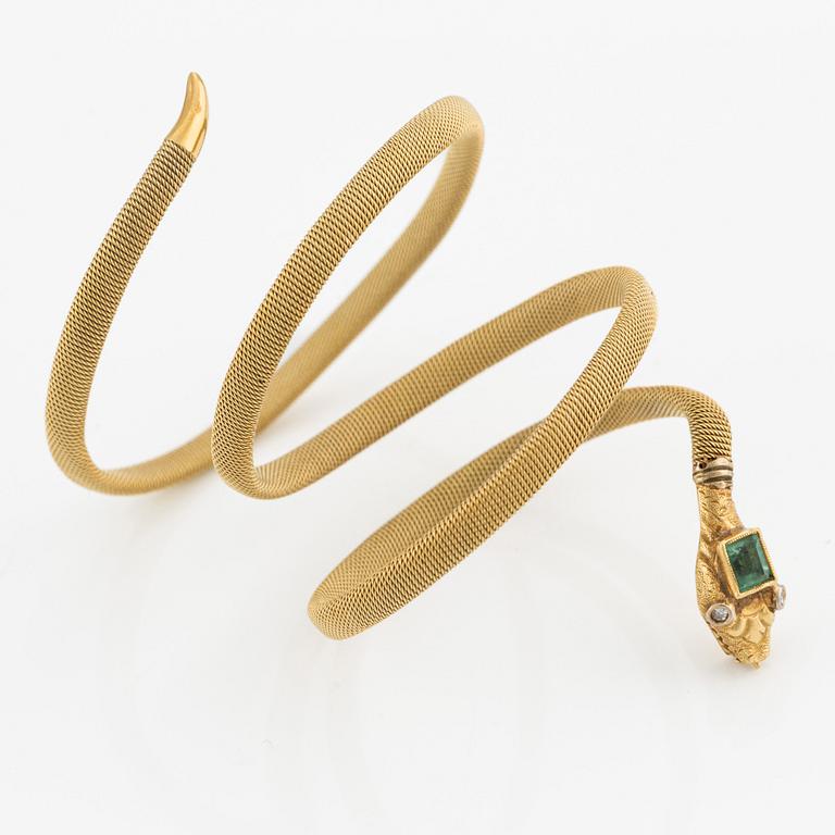 An 18K gold snake bracelet with an emerald and eight-cut diamonds.