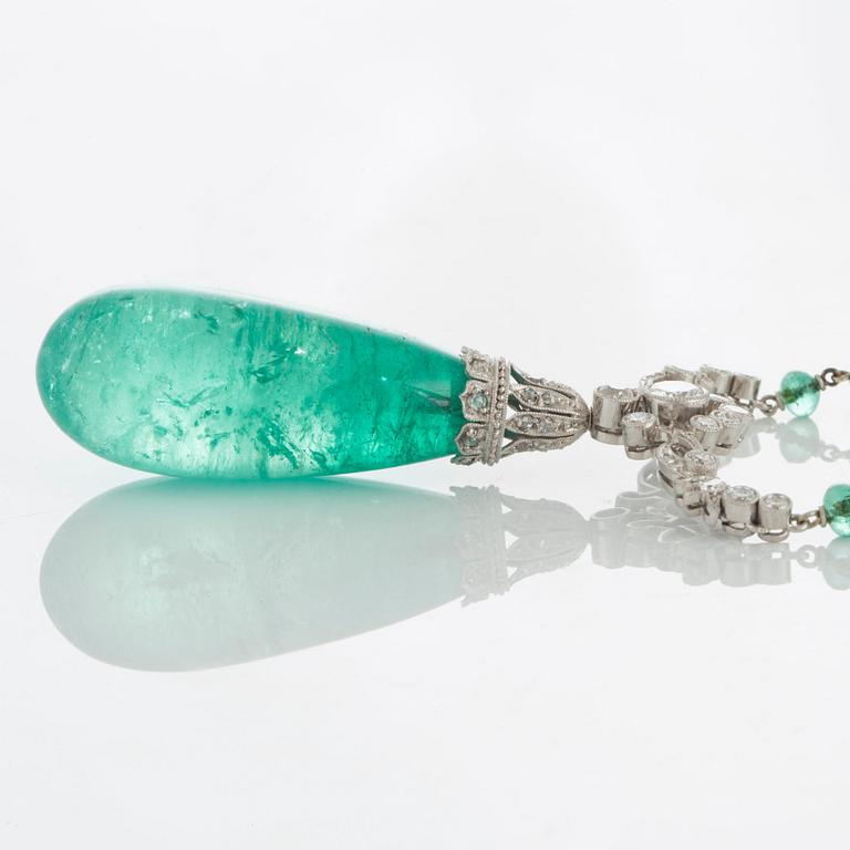 An emerald and diamond pendant with the emerald measuring ca 14.8 X 13.7 X 33.0 mm.