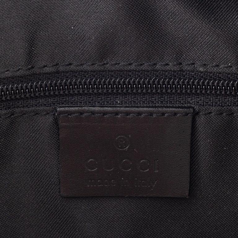 Gucci, a canvas handbag.