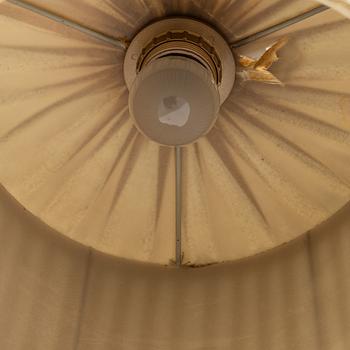 An iron floor lamp, early 20th Century.