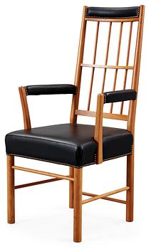 A Josef Frank cherrywood and black leather armchair by Svenskt Tenn, model 652.