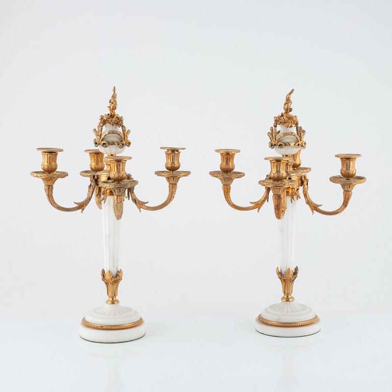 A pair of Louis XVI-style marble and gilt-bronze four-light candelabra, late 19th century.