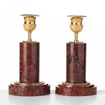 Two matched of 19th century Empire-style porphyry  candlesticks.