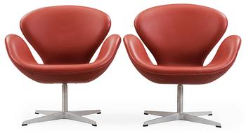 64. A pair of Arne Jacobsen red leather 'Swan' chairs, Fritz Hansen, Denmark 2001.