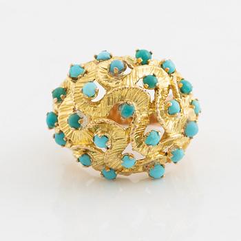 A 14K gold ring set with turquoises.
