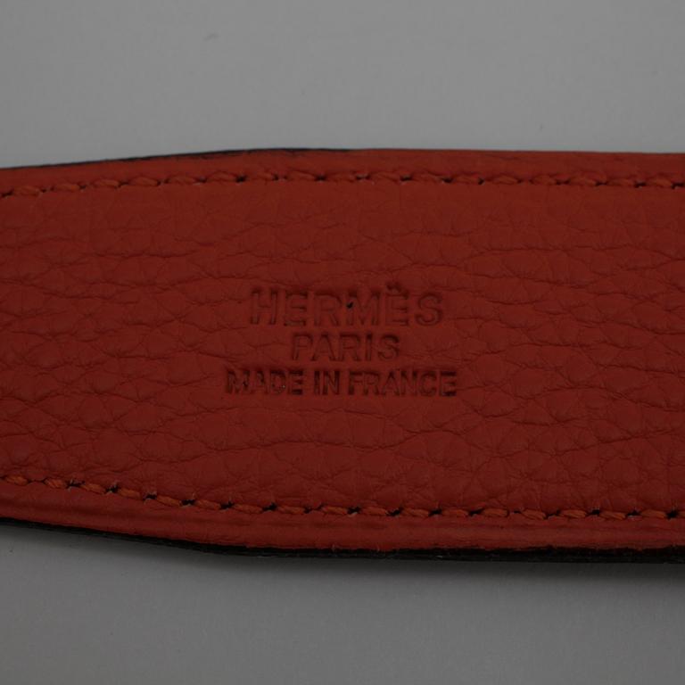 HERMÈS, a black leather belt.