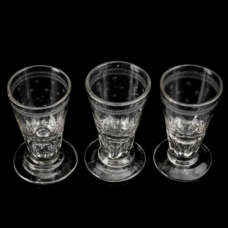 A glass bottle and three vodka glasses, 19th Century.