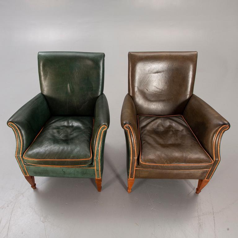 A set of two leather armchairs lat er part of the 20th century.