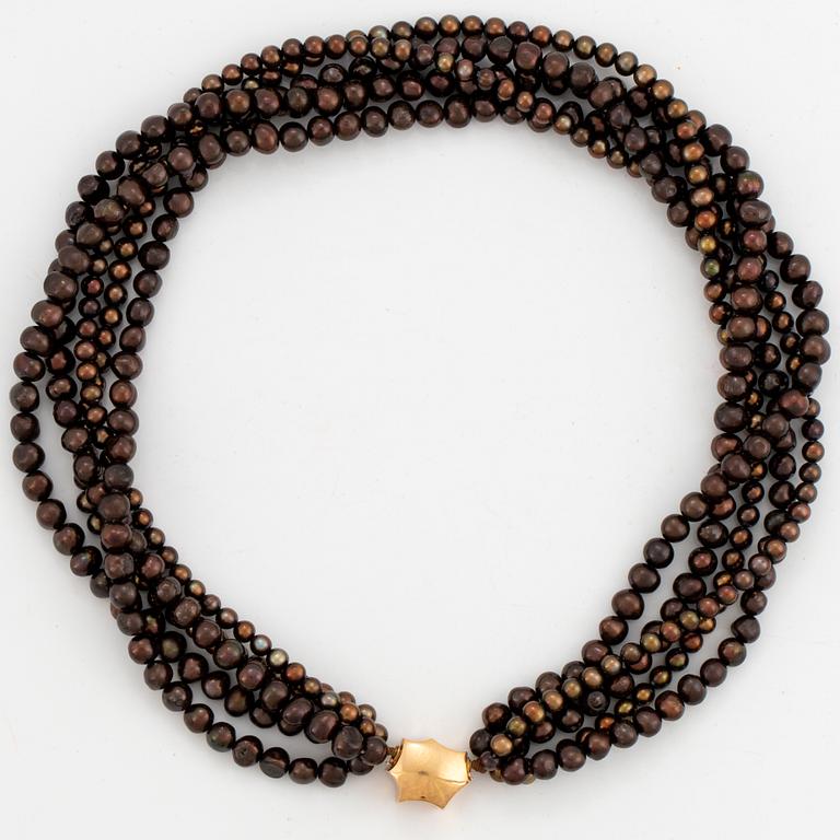A five strand cultured pearl necklace.