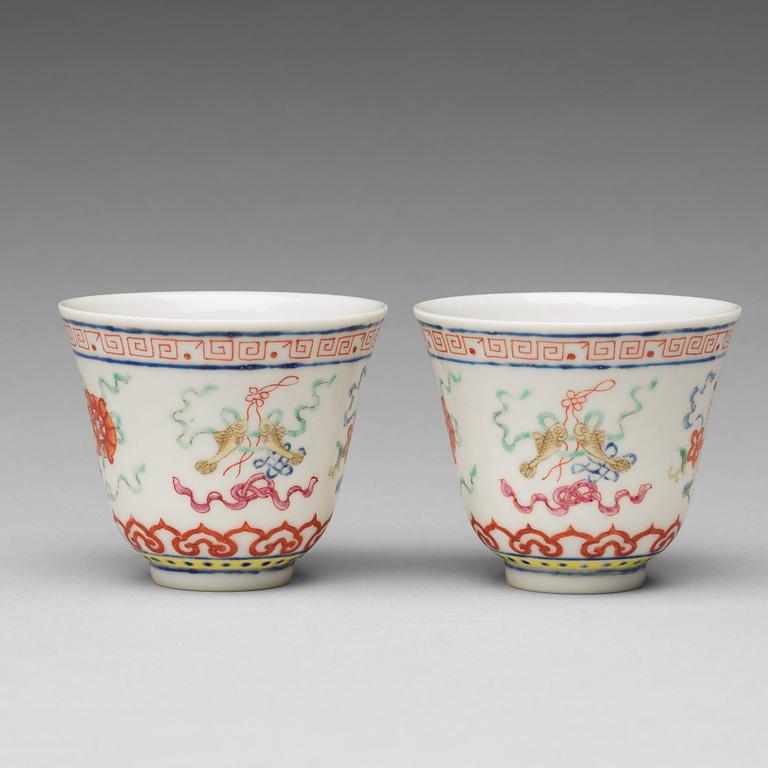 A pair of Chinese famille rose ba jixiang wine cups, Republic, with Guangxu six character mark.