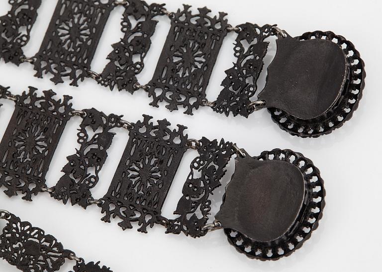 A Berlin steel and iron parure comprising a necklace, two bracelets and a brooch.