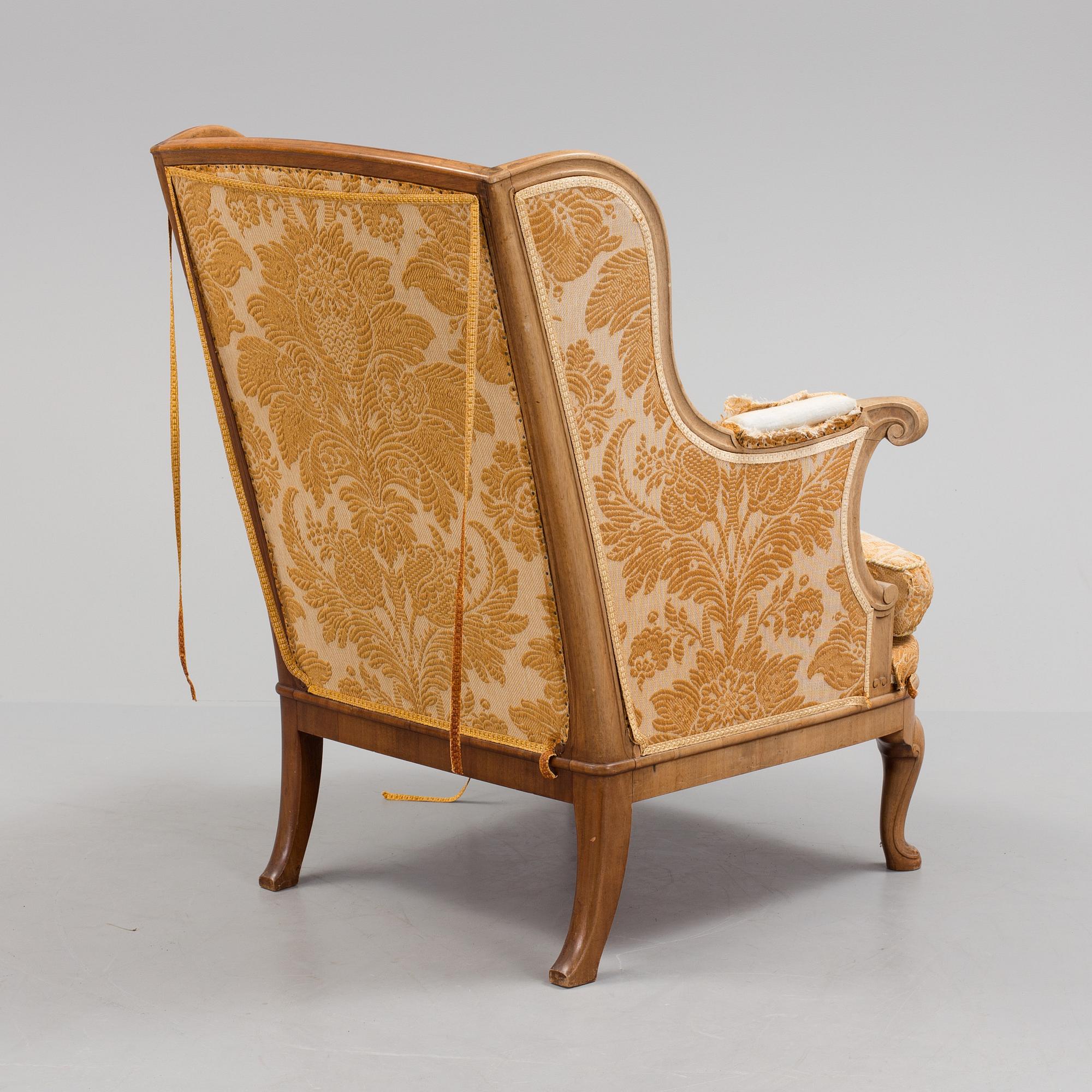 A Rococo style wing chair, first half of teh 20th Century.
