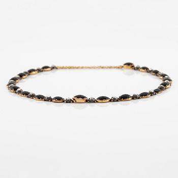 A necklace/bracelet combination 18K gold and silver set with onyx and rose-cut diamonds, 19th century.
