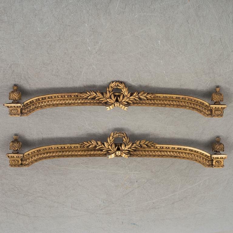 A pair of gilt Louis XVI style pelmets, circa 1900.