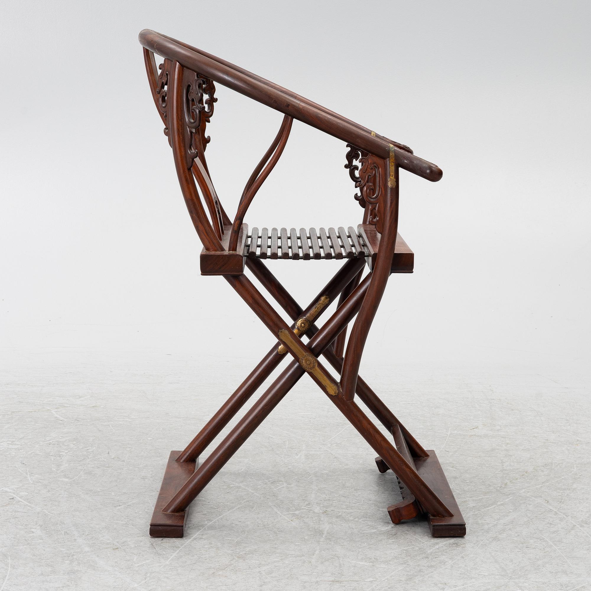 A Chinese hardwood folding chair, 20th century.