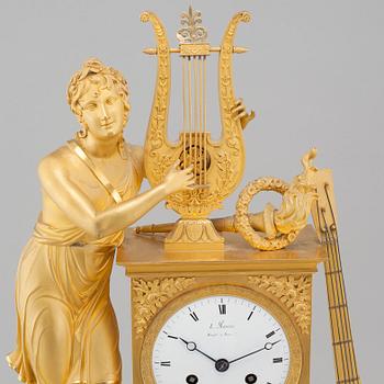 An Empire table clock, dial marked "L Ravrio Bronzier à Paris Mesnil H", fist half of the 20th century.