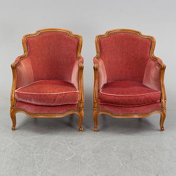 A pair of rococo style easy chairs from around the year 1900.