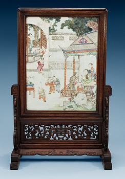 1653. A famille rose screen on a wooden stand, Qing dynasty, 19th Century.