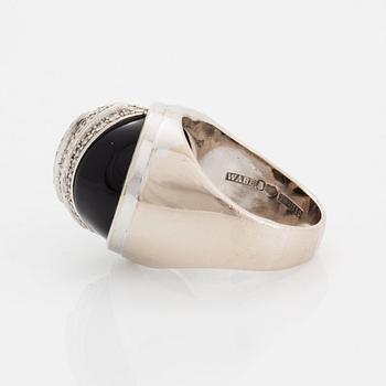 An 18K white gold and onyx ring set with round brilliant-cut diamonds.