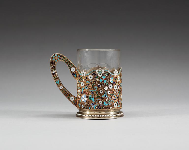 A RUSSIAN SILVER-GILT AND ENAMEL TEA-GLASS HOLDER, Makers mark of 11th Artel, Moscow 1908-1917.