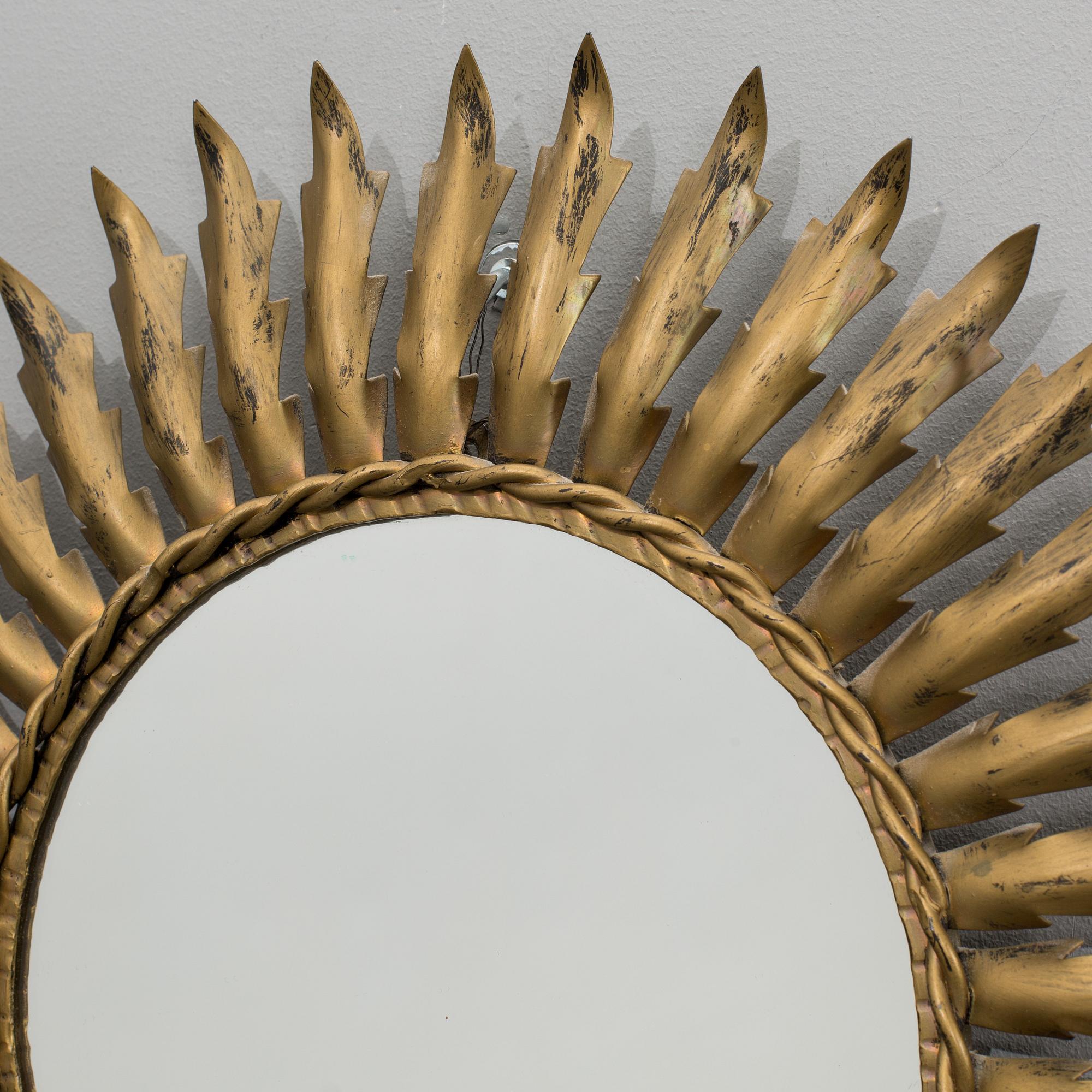 A 20th century metal sun mirror.