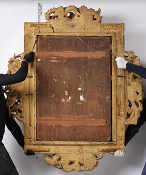 A presumably Dutch Louis XIV carved giltwood frame with mirror glass, in the style of Jean Le Pautre, late 17th century.