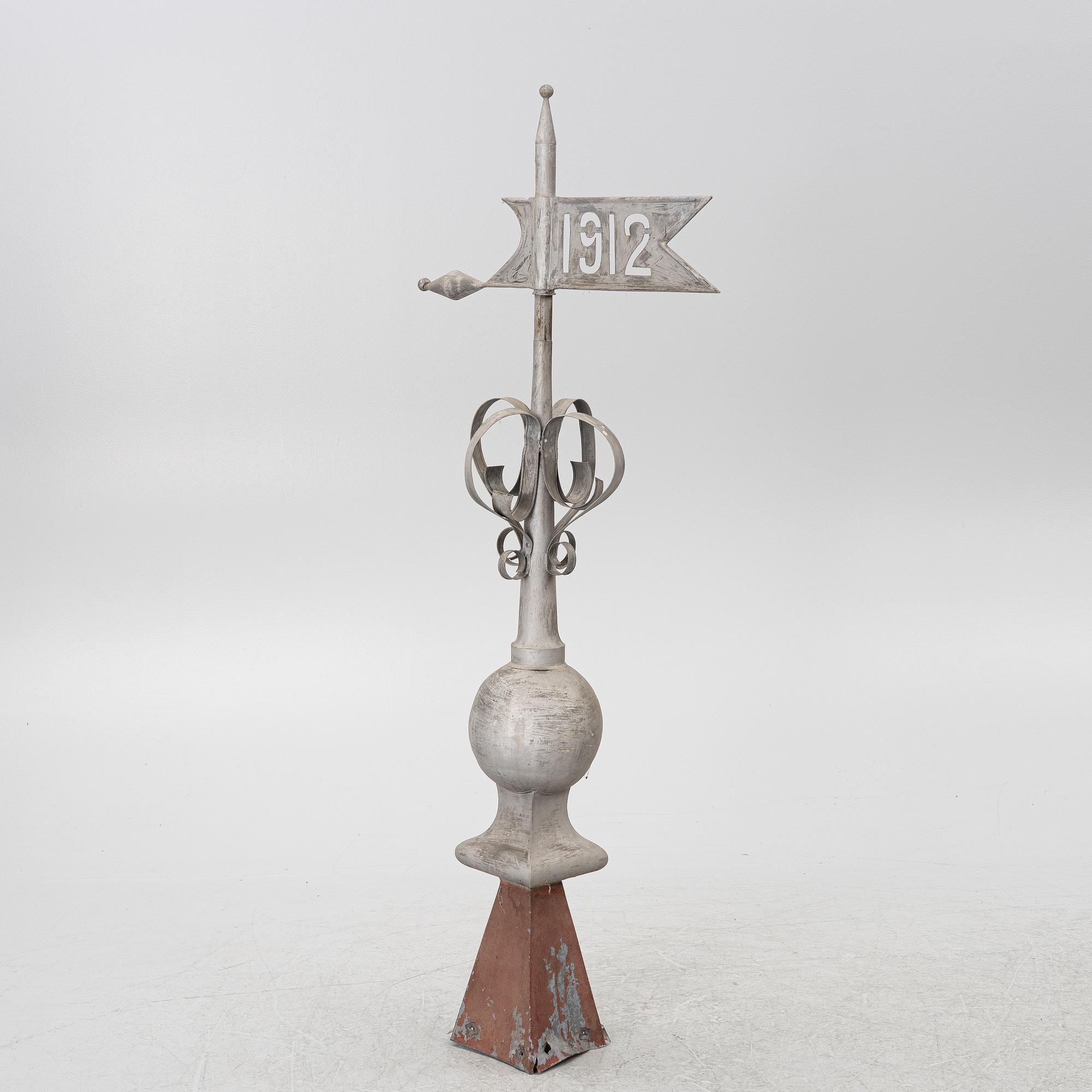 Tower spire with weather vane dated 1912.